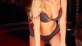 Provoking blonde stripper sensually displays bo...