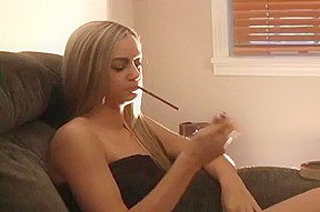 Sexy teen blonde is smoking...