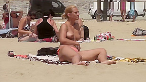 Pretty busty girl topless beach...
