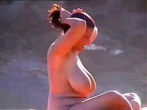 Busty nudist woman at beach...