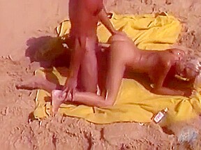 Tanned macho fucks blonde beauty on the beach with silicone breasts