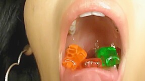 Two hot girls swallow gummy bears...
