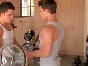 Muscled gay guys working out...
