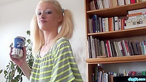 Blonde with pigtails strips in living...