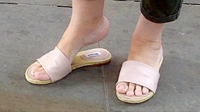 Feet soles toes in flat sandals...