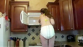 Adriana cleans microwave in messy diaper...
