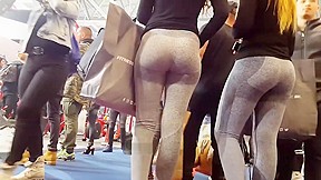 Two candid fit asses in grey yoga pants...