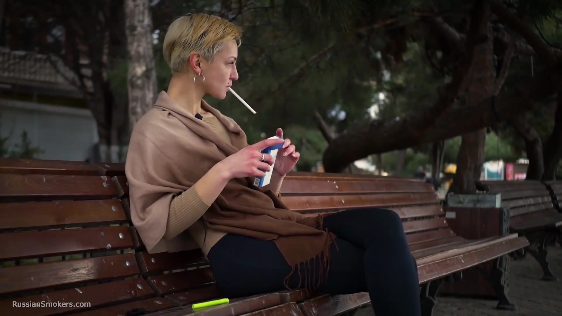 Short Cut Hair Blonde Girl Is Smoking All White 120mm Cigarettes